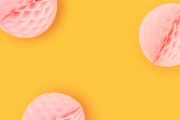 Pink tissue paper balls on a yellow background. Selective focus.