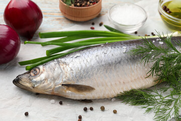 Delicious salted herring and ingredients on wooden table, closeup