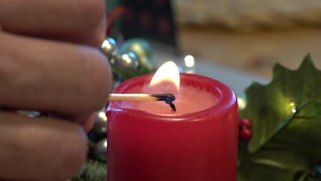 Lighting a candle on the feast day