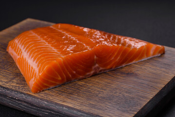 Fillet of raw red salmon fish with salt, spices and herbs