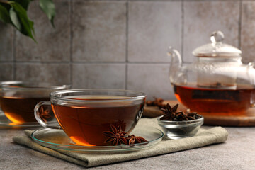Obraz na płótnie Canvas Aromatic tea with anise stars on light grey table