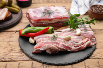 Pork fatback and ingredients on wooden table
