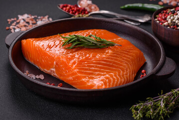 Fillet of raw red salmon fish with salt, spices and herbs