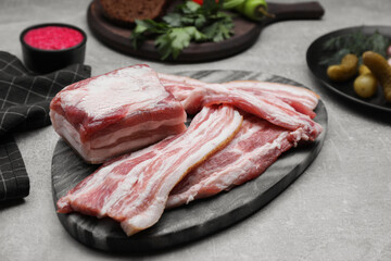 Tasty pork fatback on grey table, closeup