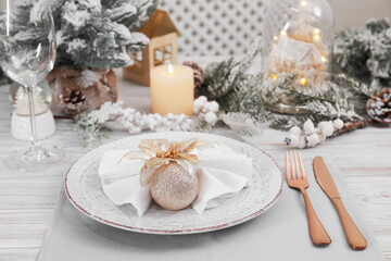 Festive place setting with beautiful dishware, cutlery and decor for Christmas dinner on white wooden table