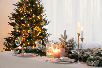 Beautiful festive table setting with Christmas decor in room