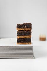 A stack of fudgy brownies, fudgy caramel brownies with a cookie crust, stack of brookies, thick brownie bars