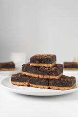 A stack of fudgy brownies, fudgy caramel brownies with a cookie crust, stack of brookies, thick brownie bars