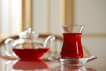 Glass of traditional Turkish tea on table indoors. Space for text