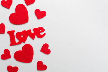 Felt word love with hearts on color background, top view