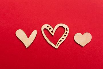 Obraz premium Wooden hearts on color background, top view