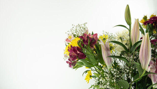Beautiful multicolored flower bouquet on white background and closeup, with lilies, chrisantemos, pompom, wildflower, etc.
