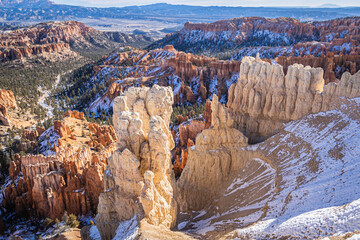 Winter scenery from Bryce Canyon National Park with brilliantly colored orange cliffs and a touch of  snow in Utah.