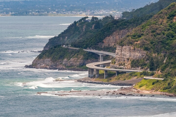 Sea Cliff Bridge, a balanced cantilever bridge built in 2005, curves around the coast of New South...