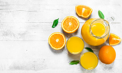 Orange juice and fresh ripe oranges.