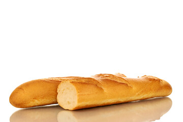 Two halves of fresh fragrant baguette, macro, isolated on white background.