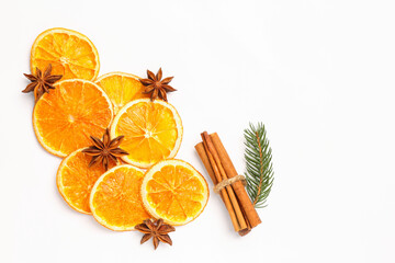 Dry orange slices, fir branch, cinnamon sticks and anise stars on white background, flat lay. Space for text