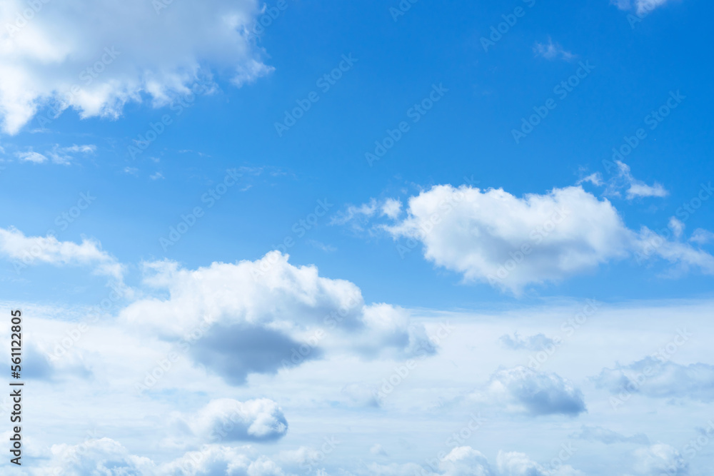 Wall mural blue sky with white fluffy clouds textured background.