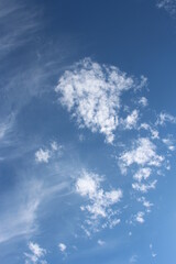 Naklejka na ściany i meble Wide shot of clouds changing shape in the blue sky