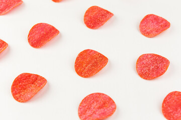 Tortilla chips pattern on a red background. Repetition concept. Top view