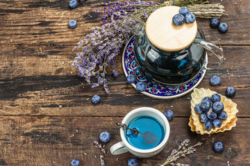 Obraz na płótnie Canvas The concept of rustic style tea. Lavender flowers and blueberries. Vintage arrangement