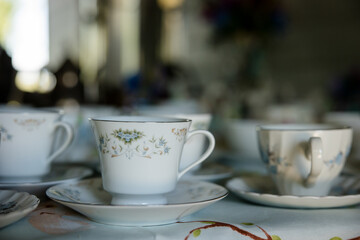 Decorative white teacups laid out for a wedding