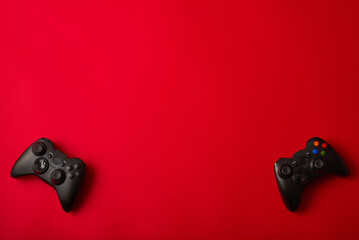 Joystick gamepad, game console on red background. Computer gaming competition videogame control confrontation concept. © stenkovlad