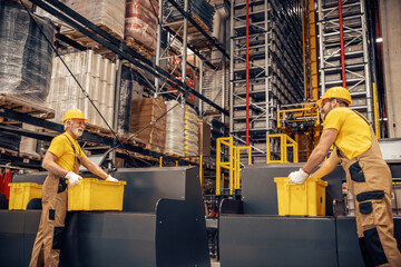 Worker in a warehouse in the logistics sector processing packages on the assembly line