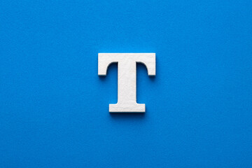 Letter T uppercase - White wood font on blue foamy background