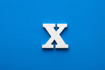 Letter X uppercase - White wood font on blue foamy background