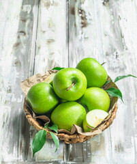 Green apples in the basket.
