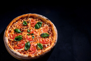 Delicious fragrant pizza with mozzarella, tomatoes and basil with tomato sauce - Margherita