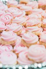 Repeating rows of cupcakes with pink frosting at a tea party