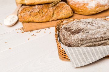 Homemade natural breads. Different kinds of fresh bread as background, perspective view with copy space