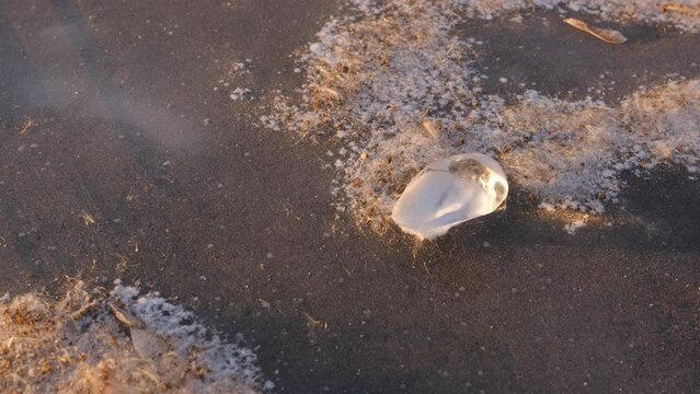 Ice crystal on the frozen lake. Beautiful winter landscape. Macro image, selective focus.