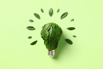 Earth Day concept. Creative idea with eco light bulb and green leaves.