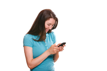 Attractive young woman texting on cellphone against white background.