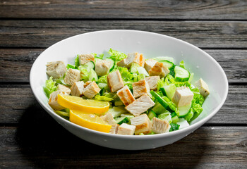 Healthy salad. Salad with cucumbers, chicken and Chinese cabbage poured lemon juice .