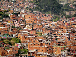 Fototapeta na wymiar The comuna 13 neighborhood in Medellin, Colombia has transformed from a former ghetto to a well-developed area, with stacked houses as a unique feature.