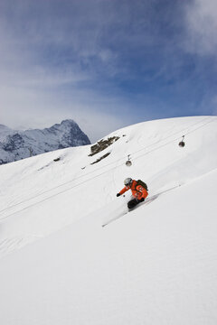 A young man skis off-piste in Grindelwald, Switzerland.