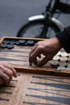 Men play backgammon on the sidewalk in Old Jaffa, Tel Aviv, Israel.