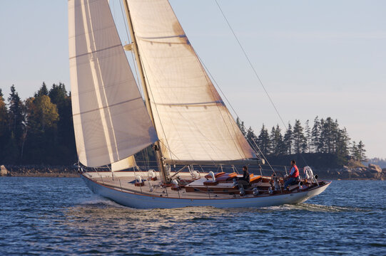 The crew of a sailing yacht takes her out for a sunset cruise off the coast of Maine.