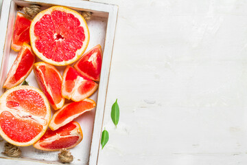 Juicy pieces of grapefruit on a tray.