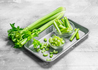 Pieces of celery in a bowl on a tray.