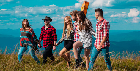 Group of friends tourists, spring banner. Young people on mountain hike. Group of friends go to mountains journey. Group of people friends enjoy outdoor lifestyle activity nature camping.