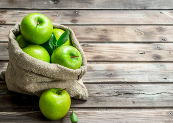 Juicy green apples in an old bag.