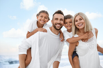 Happy family on beach near sea. Summer vacation