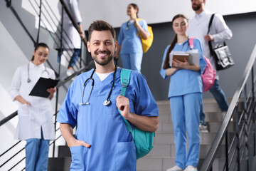 Portrait of medical student with stethoscope on staircase in college, space for text