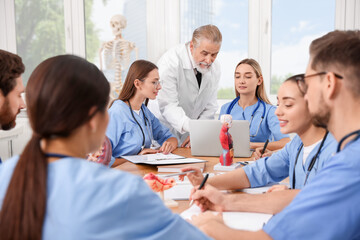 Doctor giving lecture for interns in university