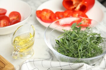Fresh microgreens for tasty salad on white marble table, closeup